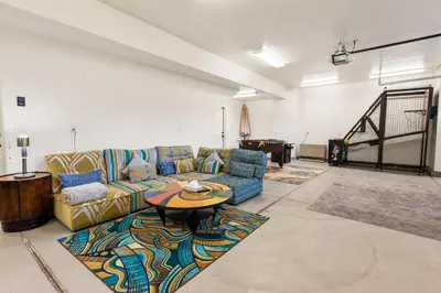 a living room with a couch and a table at Boulder Bay Chalet Lakefront - Elegantly decorated with Hot Tub and Game Room! in Big Bear Lake