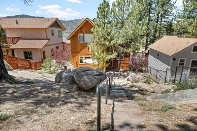 a group of houses in a yard with trees at Boulder Bay Park Lakefront - Across the street from the lake and Boulder Bay Park! Hot tub! in Big Bear Lake