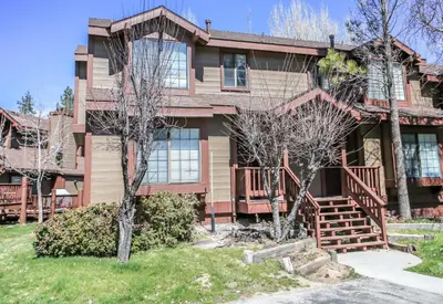 a large brown house with trees in front of it at Brown Bear's Den - Spacious condo within walking distance to all Big Bear has to offer! in Big Bear Lake