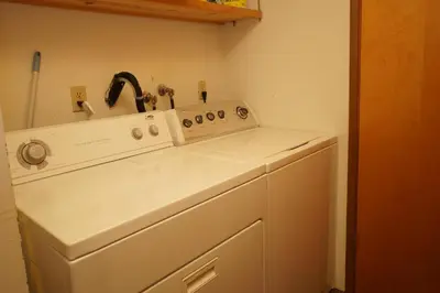 a kitchen with a sink and a dishwasher at Canyon Cabin - A quaint cabin in a peaceful location yet close to Big Bear's attractions! in Fawnskin