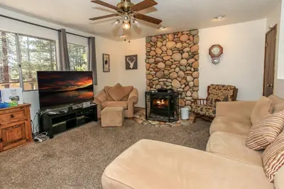 a living room with a couch and a fire place at Chalet Georgia - Spacious and cozy home, conveniently close to the heart of Big Bear! in Big Bear Lake