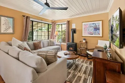 a living room with a couch and a fireplace at Chipmunk House - Magical Boulder Bay cottage within a picturesque setting! in Big Bear Lake