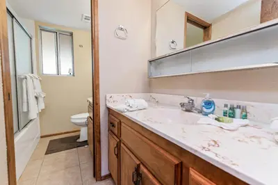 a bathroom with a sink and a toilet at Cub Run Cabin - Spacious home close to the lake with Hot tub! in Big Bear Lake