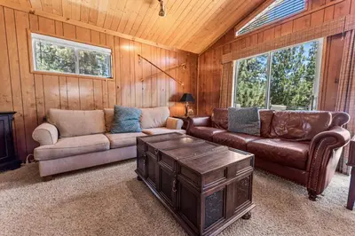 a living room with a couch and a coffee table at Cub Run Cabin - Spacious home close to the lake with Hot tub! in Big Bear Lake