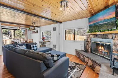 a living room with a couch and a fireplace at Dream Street Escape -Private Hot Tub, near the Village and Lake! in Big Bear Lake