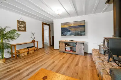 a living room with a couch and a tv at Evergreen Paradise - Beautiful newly remodeled cabin with Hot Tub and Game Room! in Big Bear Lake