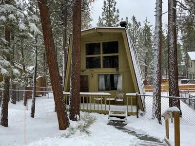 a small cabin in the woods in the snow at Fanciful Winter's Lake - Mix of old-world charm and modern-day gambrel style cabin! in Big Bear Lake