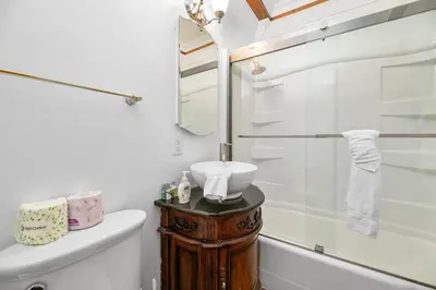 a bathroom with a toilet and a sink and a shower at Finch Nest - Beautiful cabin in a convenient location! in Big Bear Lake