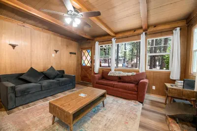 a living room with a couch and a table at Finch Nest - Beautiful cabin in a convenient location! in Big Bear Lake