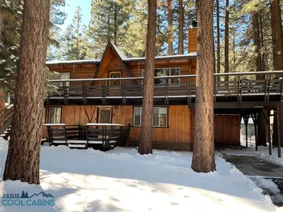 a log cabin in the woods in the snow at Gallagher's West - Pine surrounded deck and barbecue! Bumper Pool and Wet bar! Darts! in Big Bear Lake