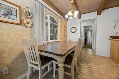 a dining room with a wooden table and chairs at Glenview Getaway - Cozy farm house! Walking distance to the lake! in Big Bear Lake