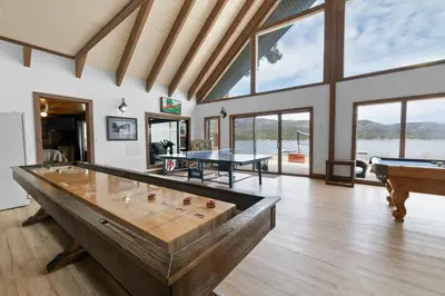 a large room with a pool table and two tables at Hakuna Matata Lakefront - LAKEFRONT, PRIVATE DOCK, AND GAME ROOM! in Big Bear Lake