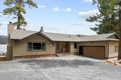 a house with a garage and a driveway at Hakuna Matata Lakefront - LAKEFRONT, PRIVATE DOCK, AND GAME ROOM! in Big Bear Lake