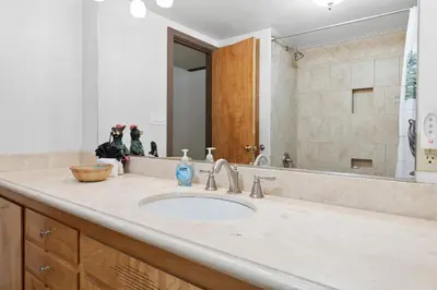 a bathroom counter with a sink and a mirror at Hakuna Matata Lakefront - LAKEFRONT, PRIVATE DOCK, AND GAME ROOM! in Big Bear Lake