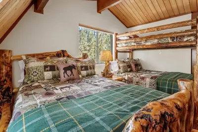 a bedroom with two beds and a window at Ivvy Bear Lodge - Charming log cabin with Hot tub! Short walk to Village! in Big Bear Lake