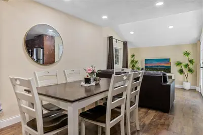 a dining room with a table and a couch at Jaybird Lodge - Large and spacious home near the Lake and Village! in Big Bear Lake