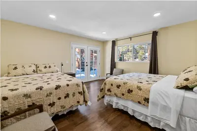 a bedroom with two beds and a window at Jaybird Lodge - Large and spacious home near the Lake and Village! in Big Bear Lake