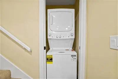 a washer and dryer sitting on top of a refrigerator at Jaybird Lodge - Large and spacious home near the Lake and Village! in Big Bear Lake
