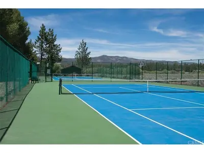 a tennis court with two tennis on at Junipine Lakefront Condo - Walking distance to the lake! Less than 2 miles from the slopes! in Big Bear Lake