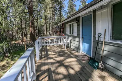 a front porch of a house with a blue door at Knotty Knight- Walking distance to the lake as well as the Village! in Big Bear Lake