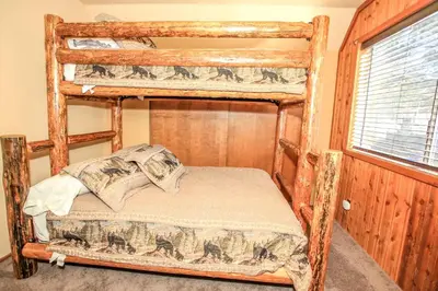 a bedroom with two bunk beds and a window at Village Hideaway - Perfectly cozy cabin with a beautiful location, walking distance to everything! in Big Bear Lake