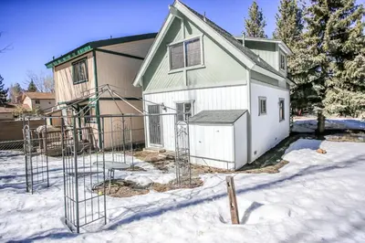 a house under construction in the snow at Village Hideaway - Perfectly cozy cabin with a beautiful location, walking distance to everything! in Big Bear Lake