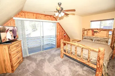a bedroom with a bed and a ceiling fan at Village Hideaway - Perfectly cozy cabin with a beautiful location, walking distance to everything! in Big Bear Lake