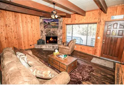 a living room with a couch and a fireplace at Village Hideaway - Perfectly cozy cabin with a beautiful location, walking distance to everything! in Big Bear Lake