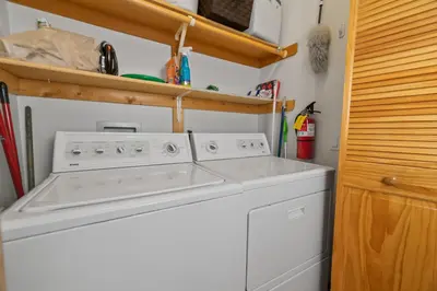 a white washer and dryer in a small kitchen at Treetop Bearadise - Best mountain living in a nicely furnished and decorated home in Big Bear Lake