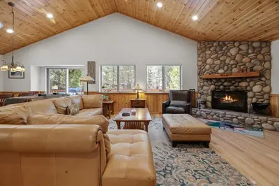 a living room with couches and a fireplace at Treetop Bearadise - Best mountain living in a nicely furnished and decorated home in Big Bear Lake