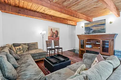 a living room with a couch and a fireplace at The Rock House - Walk to Big Bear Snow Play! Walk to Oktoberfest! Perfect weekend getaway! in Big Bear City