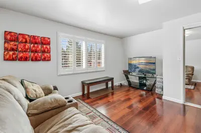 a living room with a couch and a tv at The Rock House - Walk to Big Bear Snow Play! Walk to Oktoberfest! Perfect weekend getaway! in Big Bear City