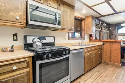 a kitchen with a stove and a microwave at The Voges' Lake House - Amazing lake front house with a beautiful view and game room! in Big Bear Lake