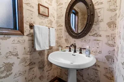 a bathroom with a sink and a mirror at The Voges' Lake House - Amazing lake front house with a beautiful view and game room! in Big Bear Lake