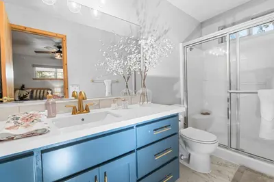 a bathroom with a sink and a shower and a toilet at The Grizzlies Den - Log style cabin located in the desirable Fox Farm area! Games and arcade! in Big Bear Lake