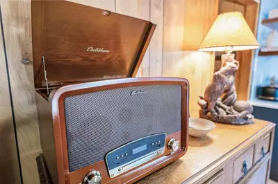 an old television sitting on a table with a lamp at The Oasis Chalet - Walking distance to The Village, The Lake, and Alpine Slide! in Big Bear Lake