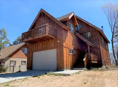 a large wooden barn with a garage at The Fox Paw - Cozy and spacious cabin! Family game room with Foosball and Pool Table! Jet Tub! in Big Bear Lake