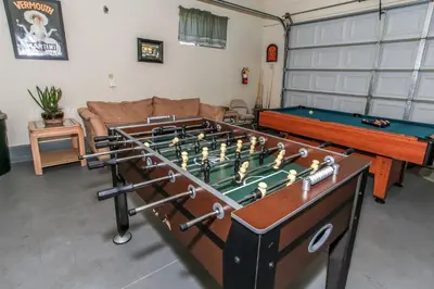 a living room with a pool table and a pool table at The Fox Paw - Cozy and spacious cabin! Family game room with Foosball and Pool Table! Jet Tub! in Big Bear Lake