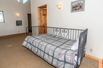 a bedroom with a bed with a blanket on it at The Fox Paw - Cozy and spacious cabin! Family game room with Foosball and Pool Table! Jet Tub! in Big Bear Lake