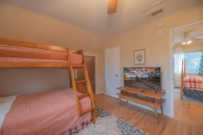 a bedroom with a bunk bed and a piano at Sweet Retreat - Spectacular little hideaway, cozy family getaway near the lake! in Big Bear Lake