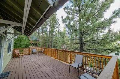 a deck with chairs and tables on a house at Sweet Retreat - Spectacular little hideaway, cozy family getaway near the lake! in Big Bear Lake