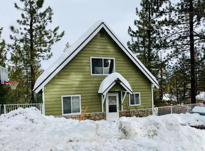 a house with snow on the ground in front of it at Sweet Retreat - Spectacular little hideaway, cozy family getaway near the lake! in Big Bear Lake
