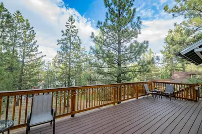a deck with two chairs and a table at Sweet Retreat - Spectacular little hideaway, cozy family getaway near the lake! in Big Bear Lake