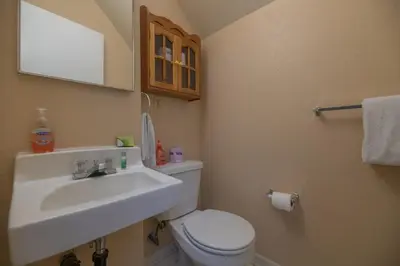 a bathroom with a sink and a toilet and a mirror at Sweet Retreat - Spectacular little hideaway, cozy family getaway near the lake! in Big Bear Lake
