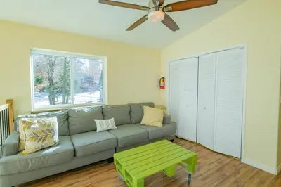 a living room with a couch and a ceiling fan at Modern Times - Amazing place with super open concept! Jet tub! in Big Bear Lake