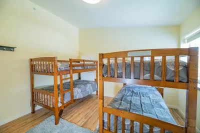 two bunk beds are in a room with at Modern Times - Amazing place with super open concept! Jet tub! in Big Bear Lake