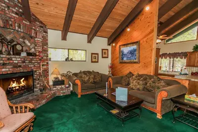 a living room with two couches and a fireplace at Summit Adventure - Beautiful, spacious and quiet home! Foosball, pool and poker table! Jet tub! in Big Bear Lake