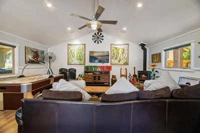 a living room with a couch and a pool table at Summit Mountain Lodge - Amazing location just down the street from Snow Summit! in Big Bear Lake