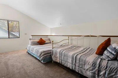 a bedroom with two beds and a window at Summit X-ross Roads - Just a short drive to the Village and the lake with forest views! in Big Bear Lake