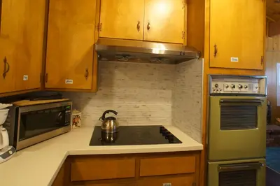 a kitchen with a tea kettle on the stove at Snowridge - Charming classic cabin with a wood burning fireplace and WiFI! in Big Bear City